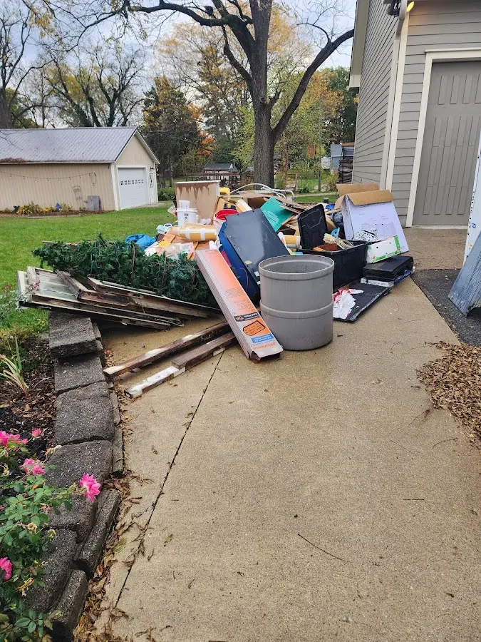 Dumpster being loaded with debris for 10 Yard Dumpster Rental in Hoschton